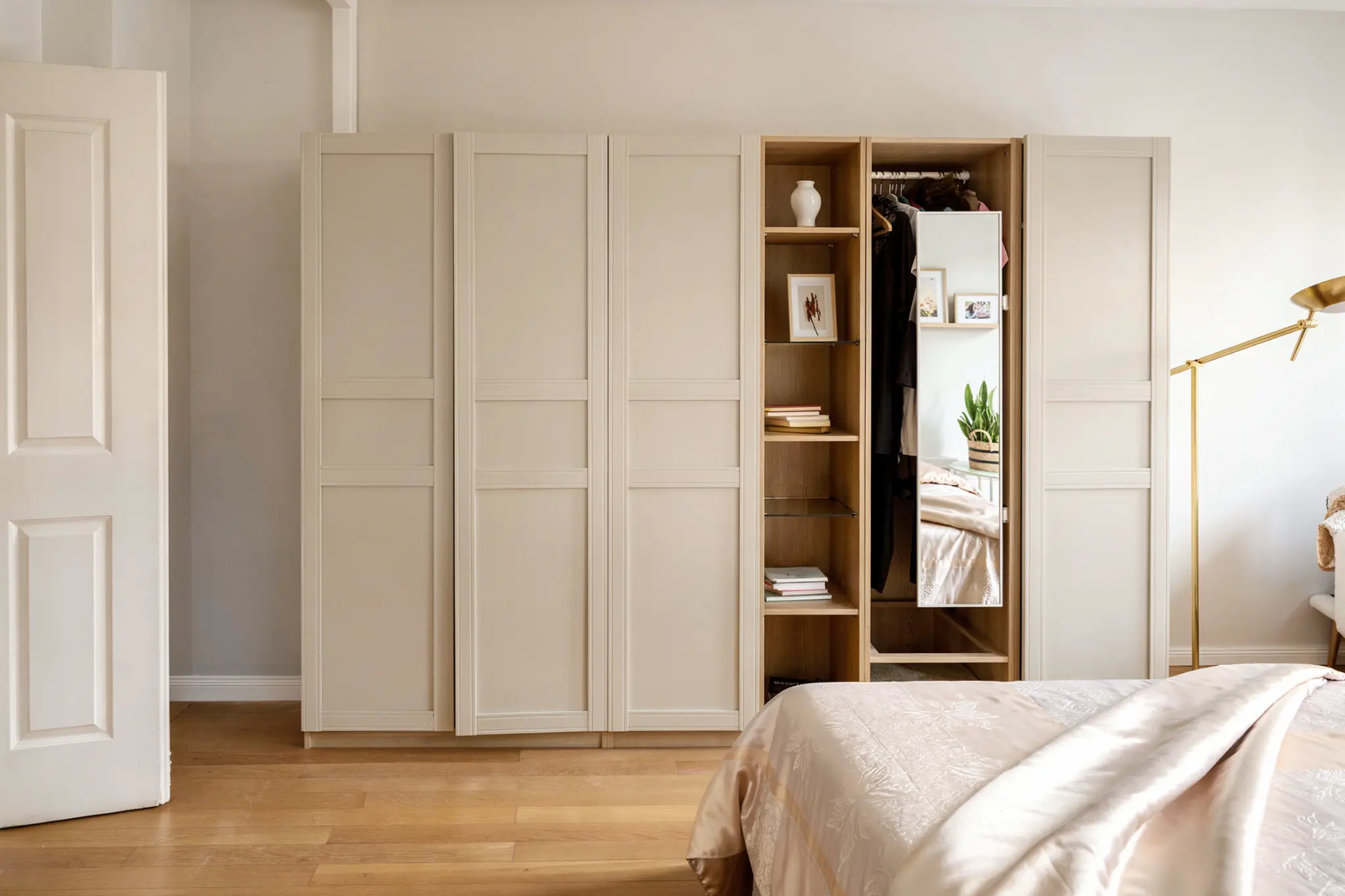 Warm bedroom with wardrobe, lamp and soft neutral details